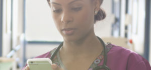 Nurse uses nursing communication on smartphone to connect with care team members