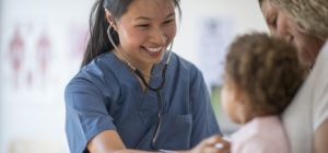 nurse checks on pediatric patient