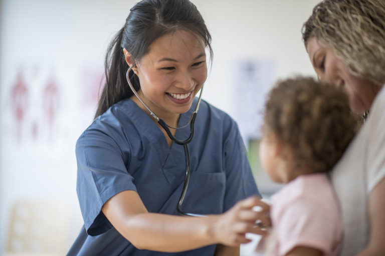 nurse checks on pediatric patient