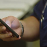 close-up of a phone being used to reduce physician burnout