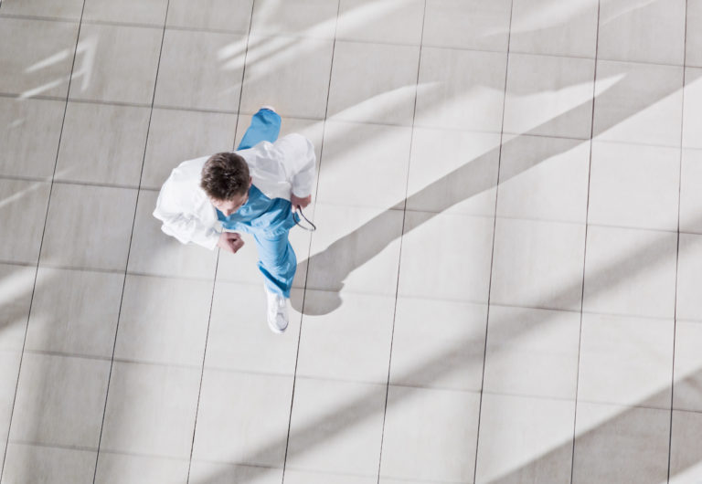 doctor running through hospital from birds eye view