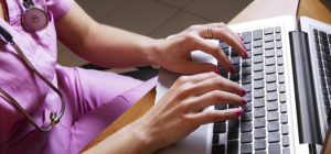 Nurse uses the new MH-CURE Desktop app on her laptop