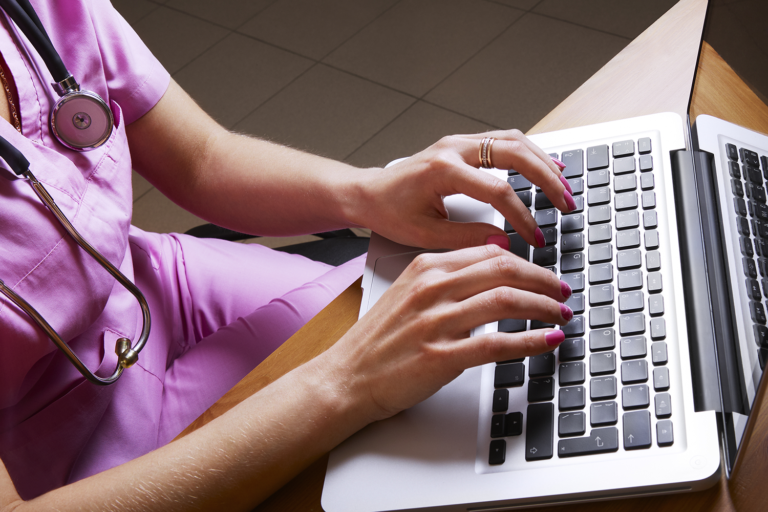 Nurse uses the new MH-CURE Desktop app on her laptop