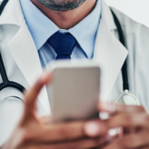 a physician uses his smartphone to call the patient care team