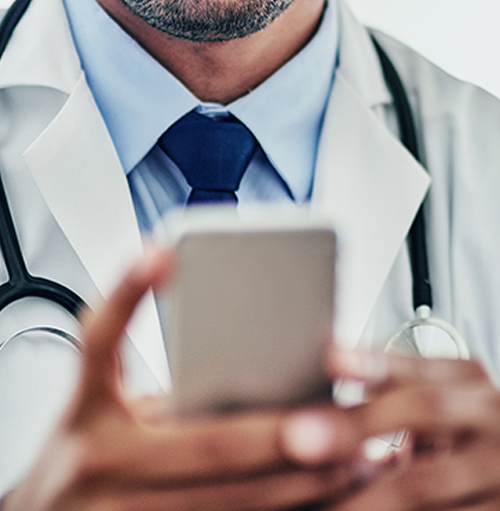 a physician uses his smartphone to call the patient care team