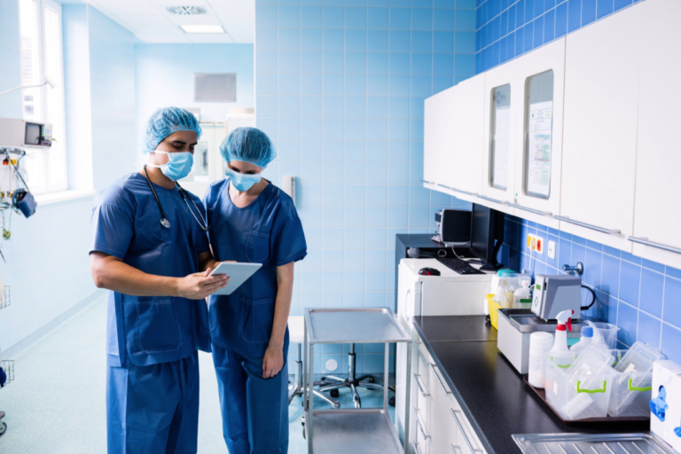 surgeons confer over a tablet